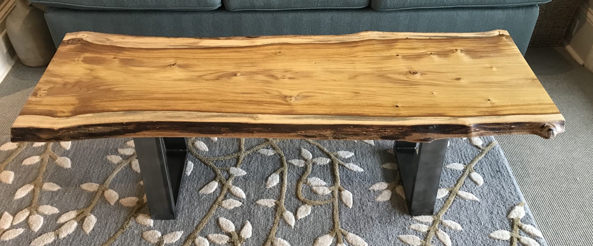 Live edge table in Canary Wood. 55”l x 18”d x 16”h.  Osmo Polyx Oil finish.
