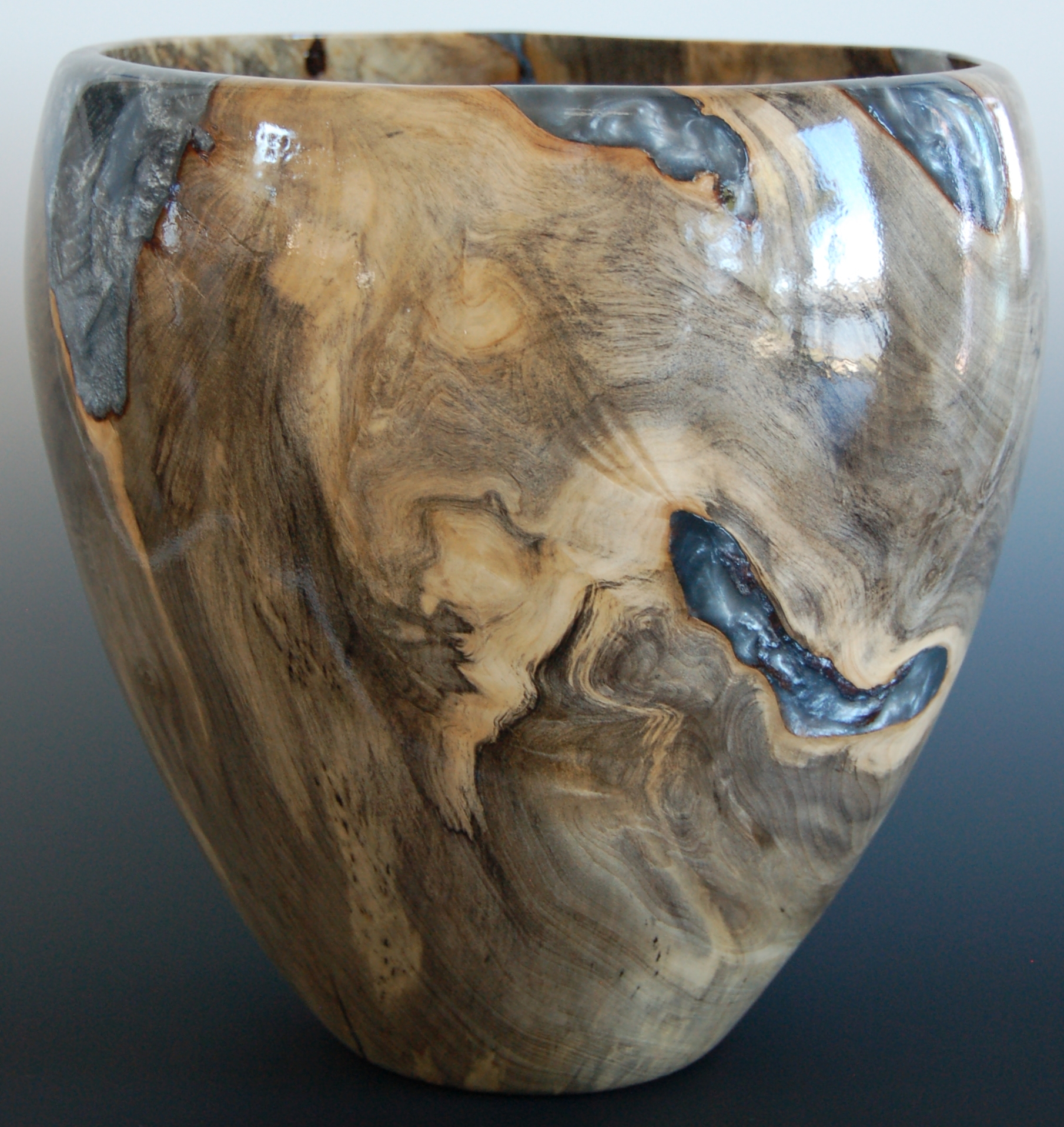 Buckeye Burl vase with pigmented resin filling in the voids