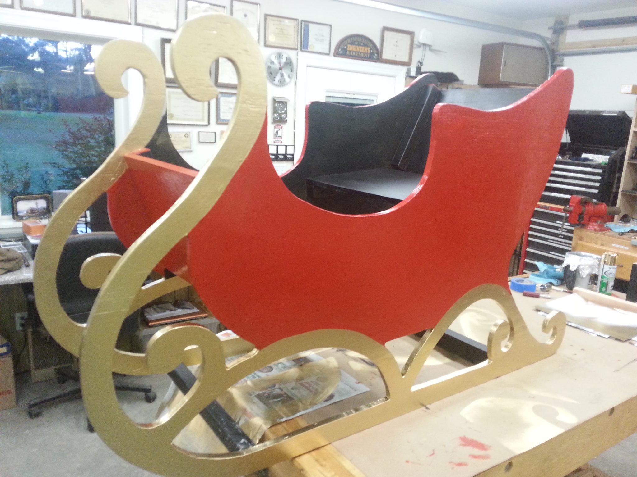 The sleigh sides were made of 1 sheet of plywood and painted. Plywood boxes were decorated by others to become Christmas gifts