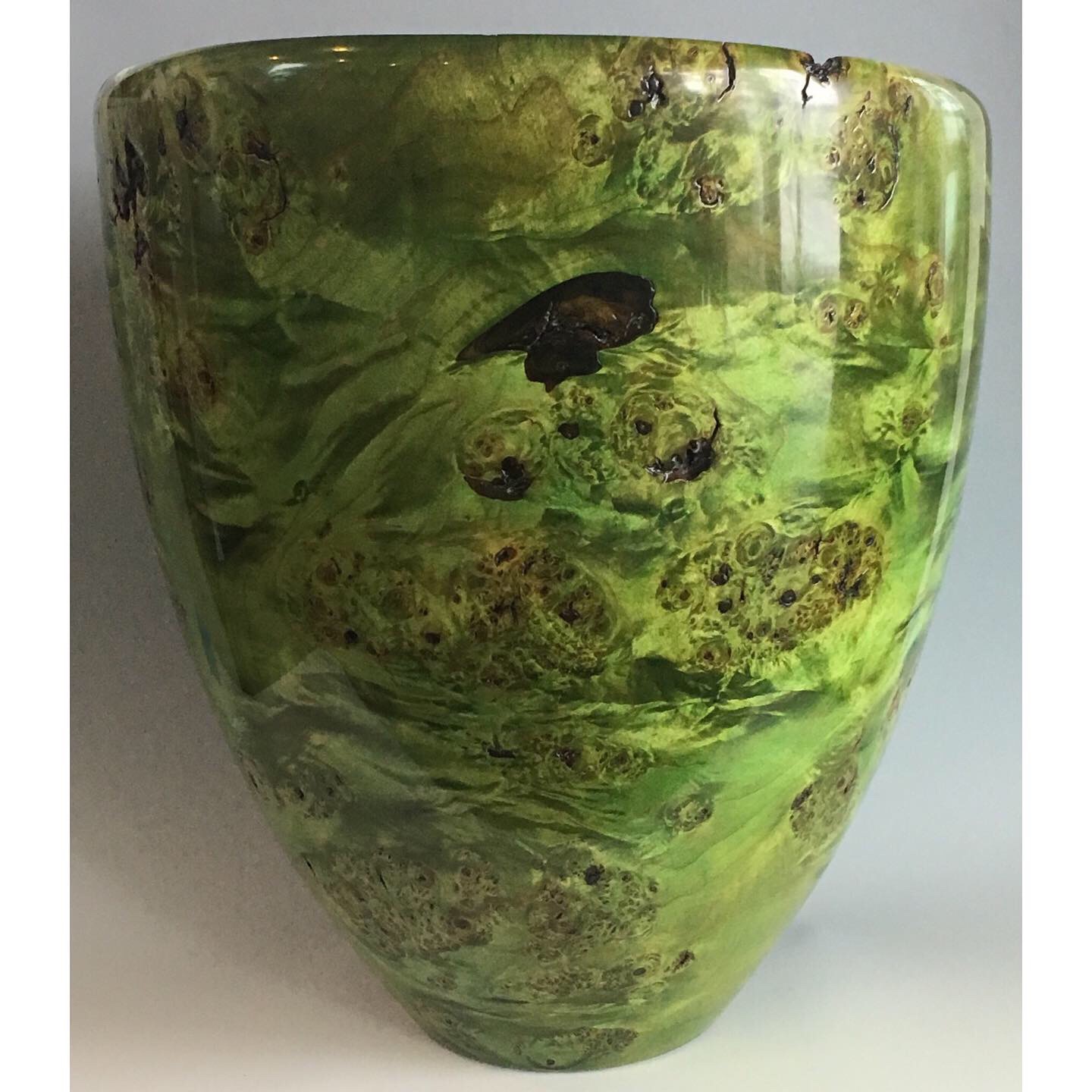 Large Maple Burl vase, dyed green on the outside and cut on a bias so the inside is visible.